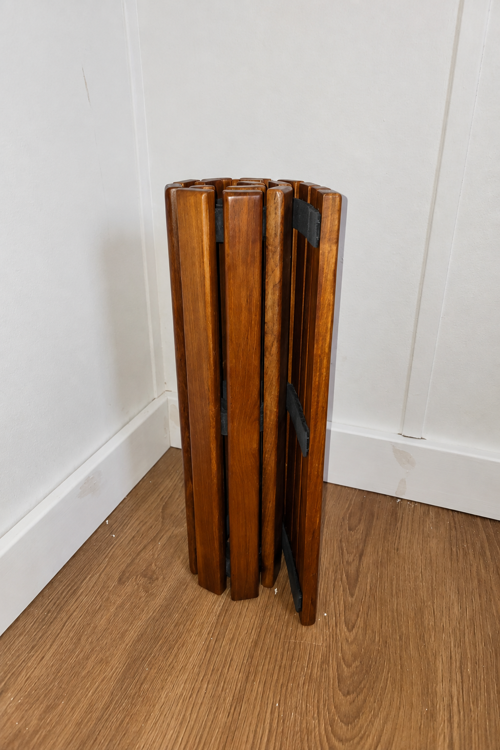 Underside of roll-up teak mat with three rubber straps